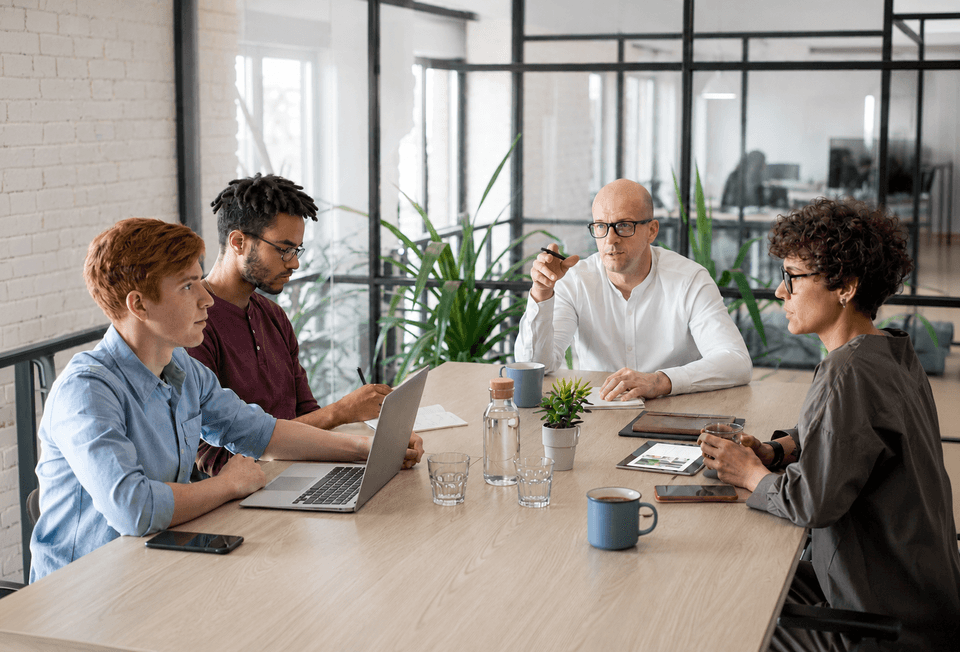 Team gathered in a workplace managed with Hamilton Apps