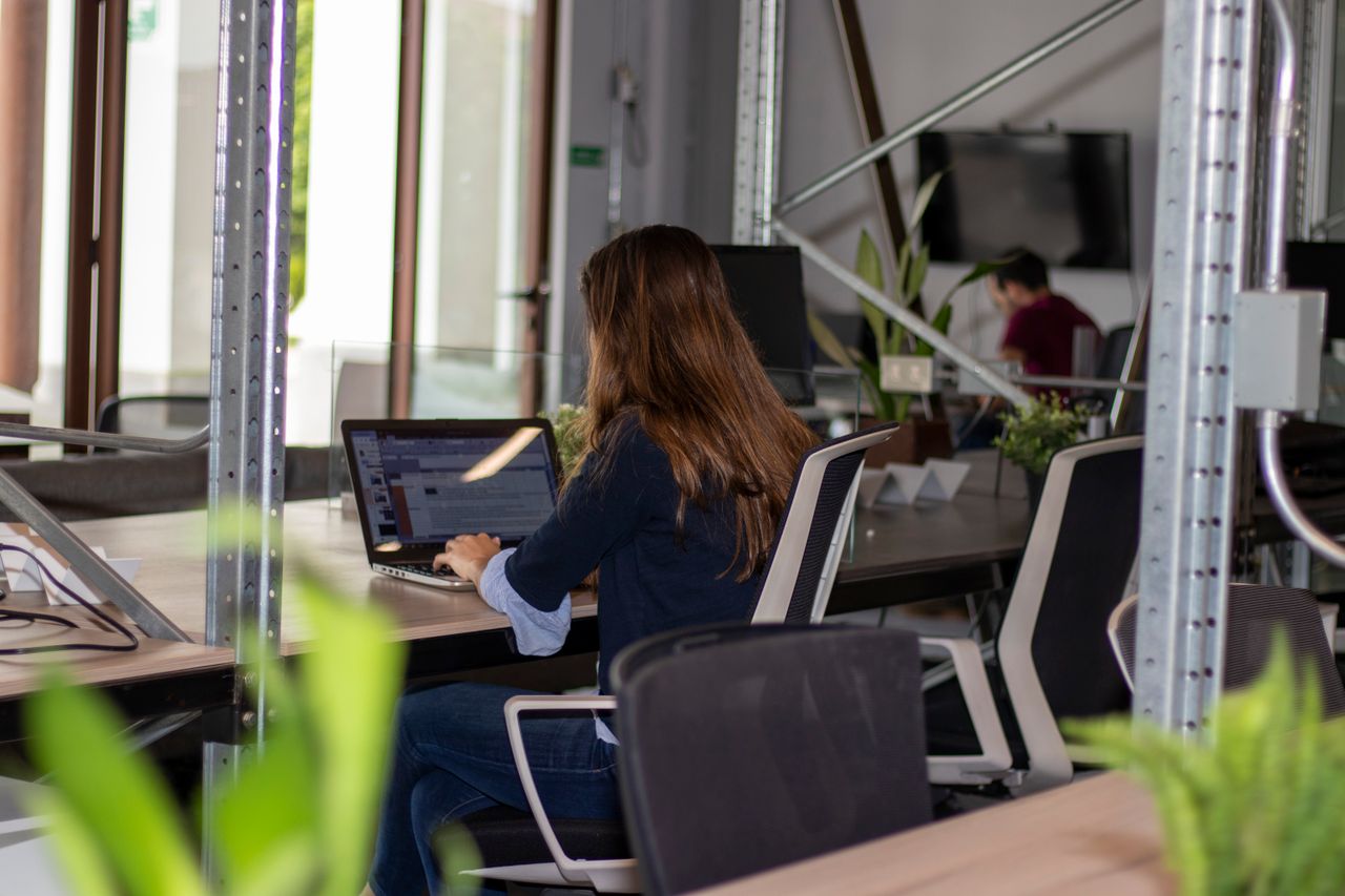 Employee working at a desk in a shared office space